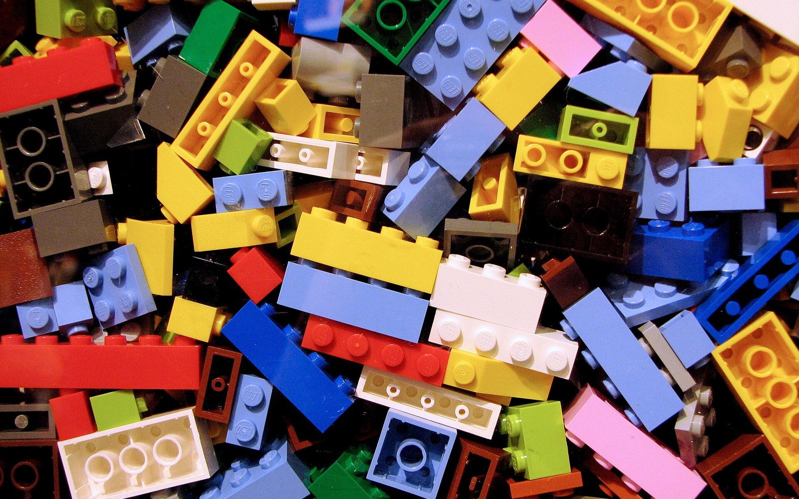 A jumbled pile of colorful Lego bricks in various shapes and sizes